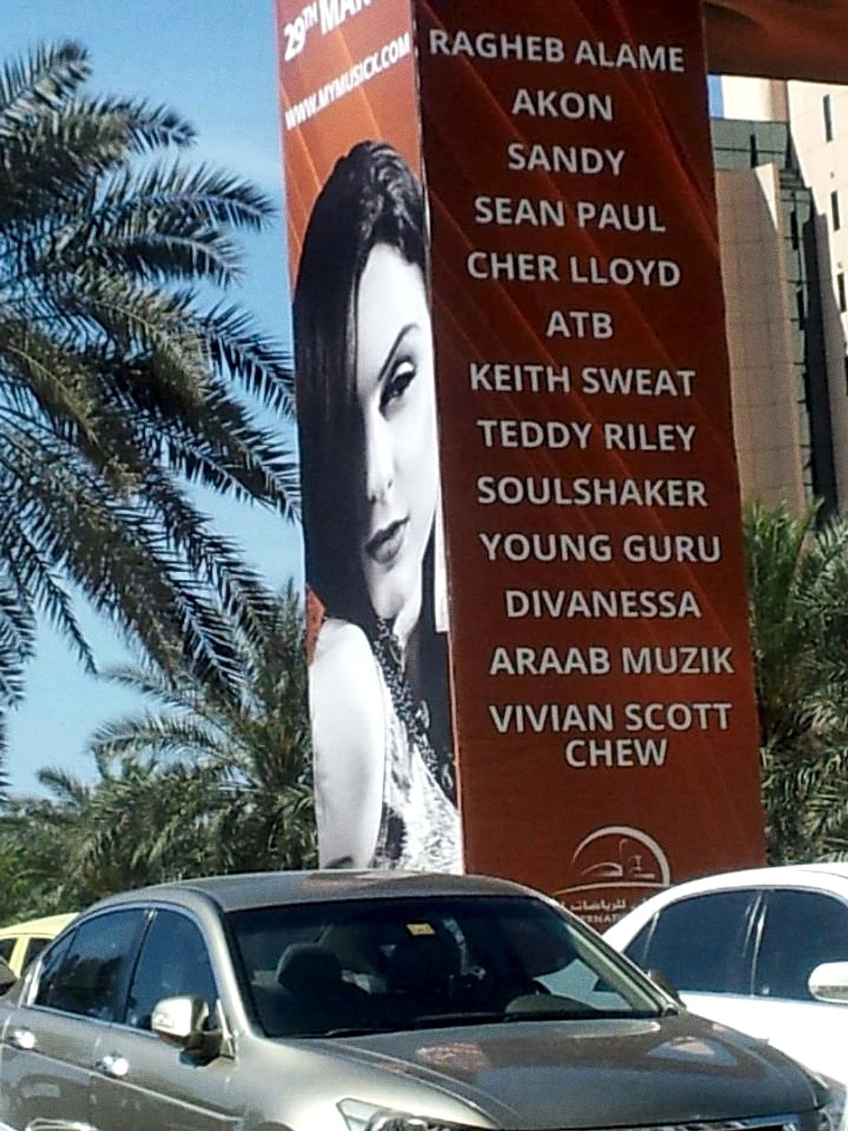 A giant roadside billboard in Dubai listing Akon, Sean Paul, Cher Lloyd, ATB, Teddy Riley, Soulshaker and others