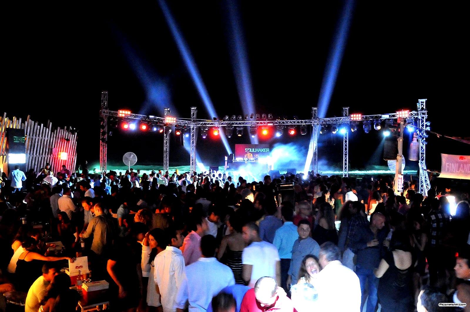 Outdoor festival stage at night with Soulshaker on the screen