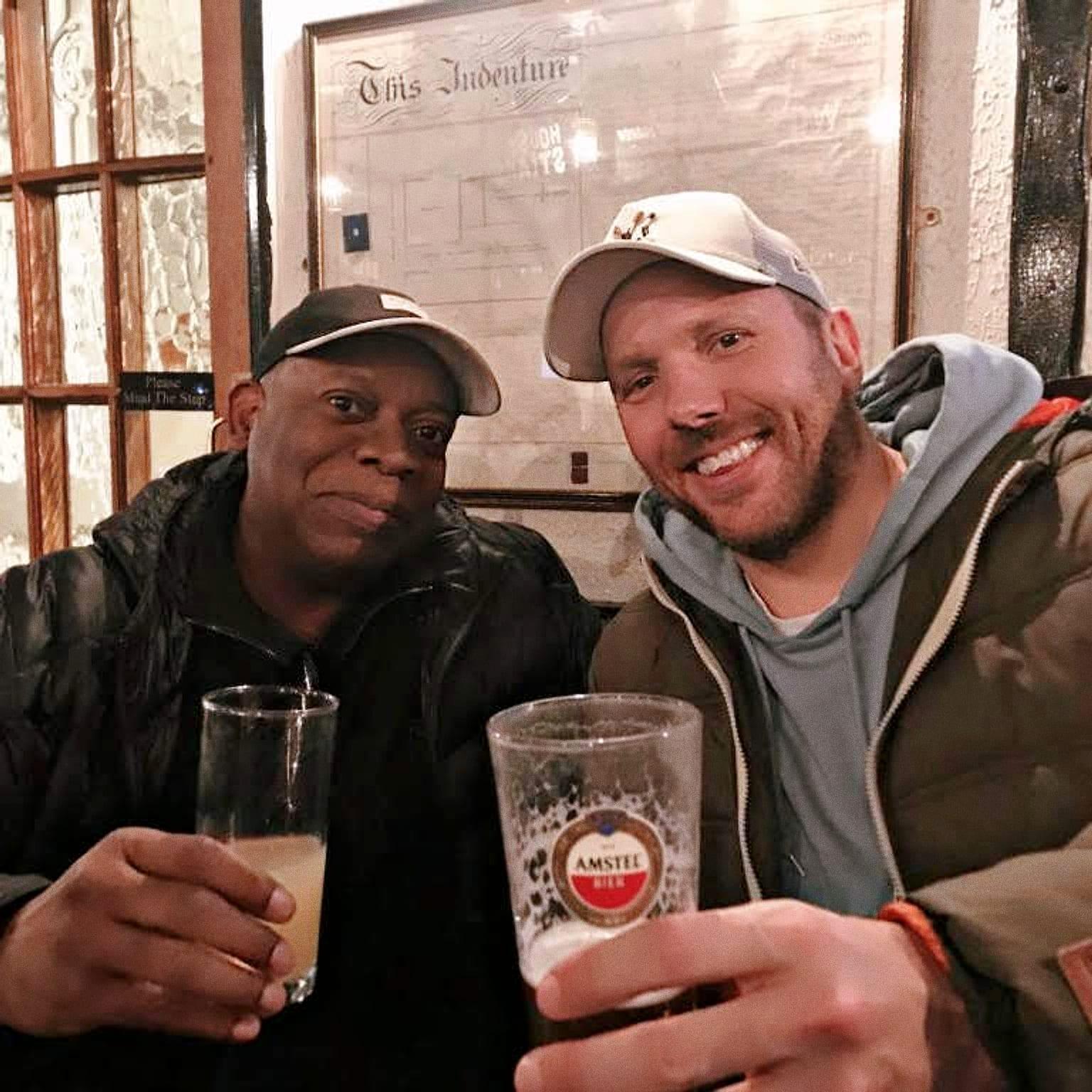 Matt and Joe Smooth raising a glass in a London pub