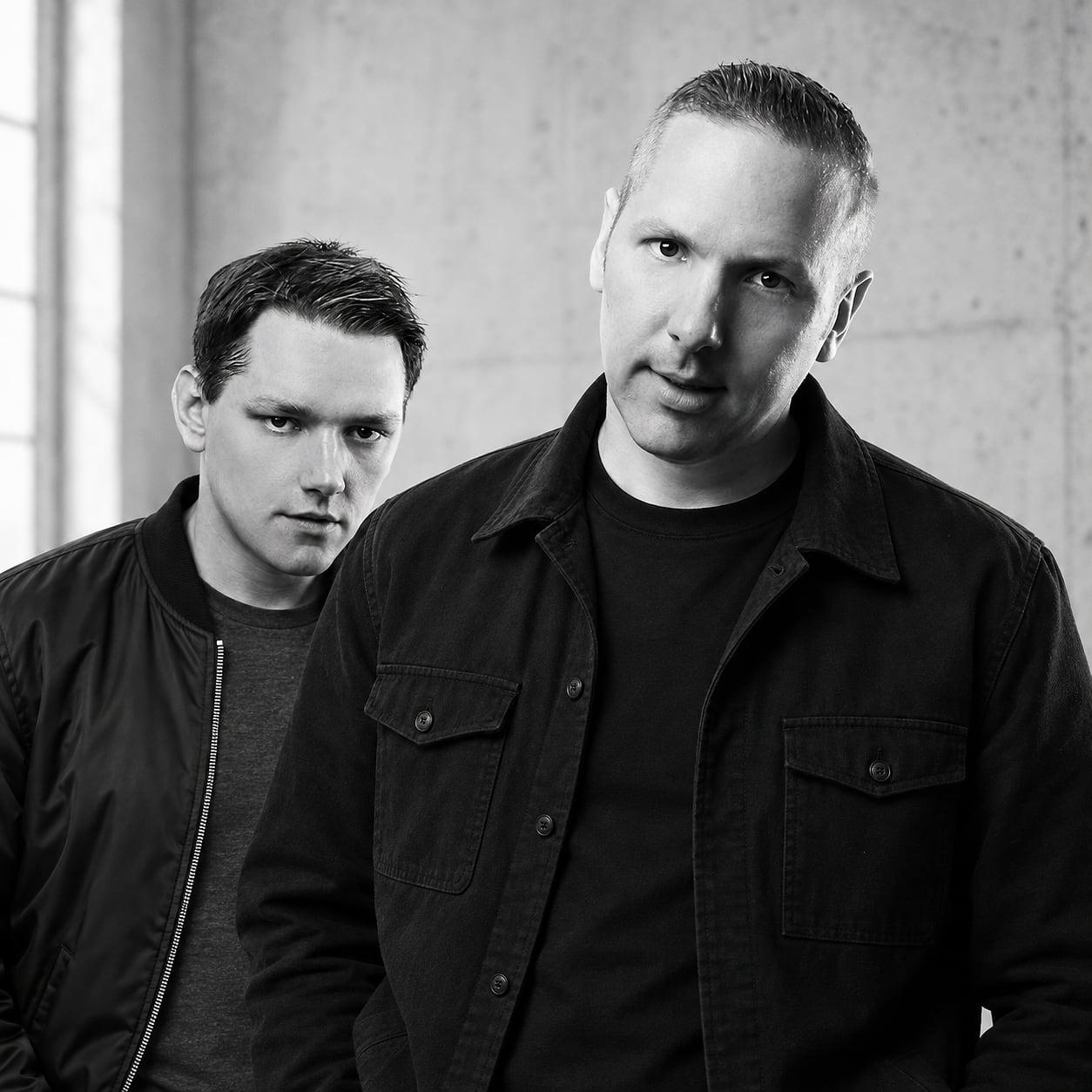 Matt and Warren against concrete, black and white