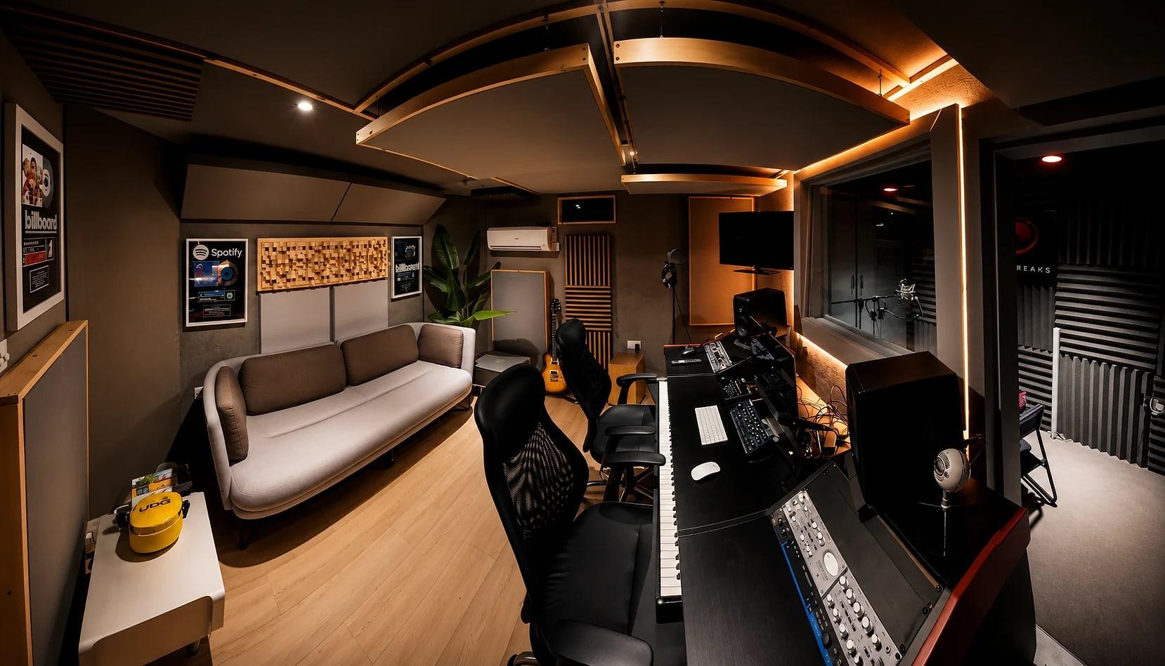 Our control room: the sofa, Spotify and Billboard plaques on the wall, and the desk looking into the vocal booth